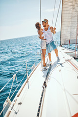 Happy man and woman on the luxury yacht enjoying together.