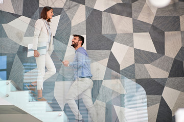 business concept: Businessman and businesswoman walking up the stair.
