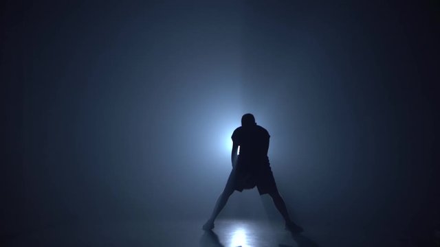 Football freestyle. Man showing tricks with ball at studio. Football freestyle.