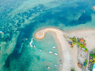 Aerial drone view of ocean, boats, beach, shore In Sanur Beach, Bali, Indonesia with with Traditional Balinese Fishing Boats amazing blue ocean. © Reezky