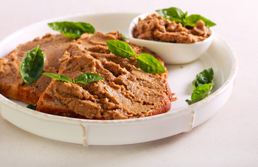 Chicken liver pate over bread slices