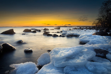 Colourful picture of rocks and ice during sunset