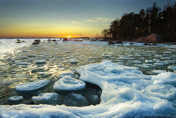 Pieces of ice floating at a shore during winter