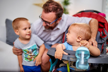 Single father going nuts with his boys and dog at home.