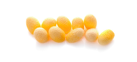 yellow thai silkworm cocoons pile isolated on white background