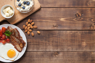 Ketogenic food: nuts, cream, bacon, berries.  Top view