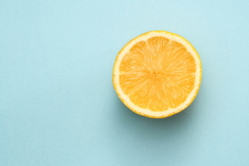 half a lemon on a blue background. Vitamins from fruits