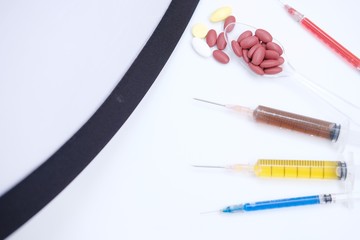Medical syringe isolated and syringes with colored liquid on white background