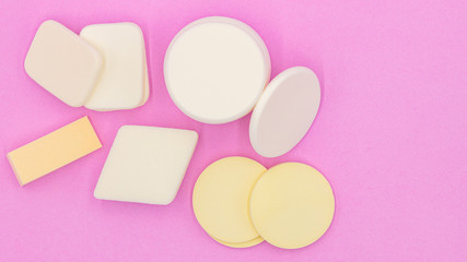 Cosmetic sponges powder for face make up on, Cosmetic sponges on pink background,