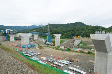 Kanagawa,Japan-July 19,2019: An incline system is lifting a cement mixer truck at a bridge building site of new Tomei Expressway near Kouchi river 