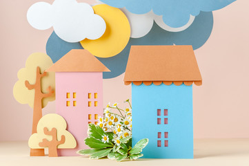 Multi-level installation of paper in children's style: Houses and flowers.