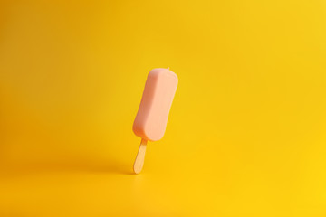 pink ice cream popsicle on yellow background