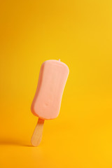 pink ice cream popsicle on yellow background