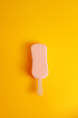 pink ice cream popsicle on yellow background