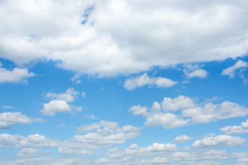 A cloudy blue sky with horizontal perspective and diffuse clouds in the bottom and dense in the top