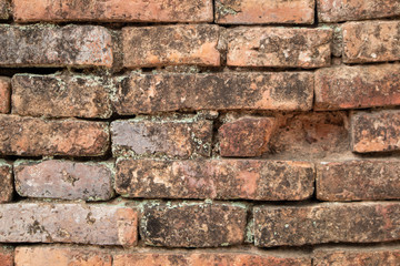 The background of the old wall was destroyed, built from red bricks.