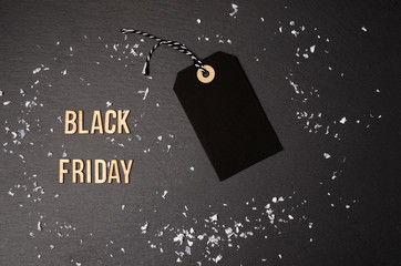 Merry Christmas black background and price label.  Black Friday. Sales concept. Copy space.  Black paper label against a dark grey background. Black Friday shopping sale concept with Black ticket Sale