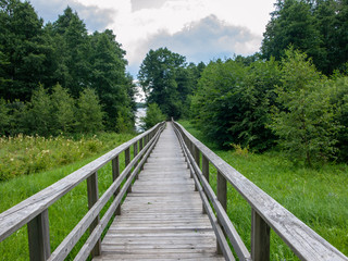 Fototapeta na wymiar Picture of a wooden bridge with a beautiful lake and clouds, Latvia