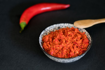 Traditional Maghrebi hot chili pepper sauce paste harissa. Marocco and arabic cuisine. Georgian adjika. Italian peperoncino sause