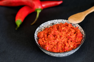 Traditional Maghrebi hot chili pepper sauce paste harissa. Marocco and arabic cuisine. Georgian adjika. Italian peperoncino sause