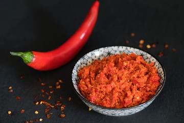 Traditional Maghrebi hot chili pepper sauce paste harissa. Marocco and arabic cuisine. Georgian adjika. Italian peperoncino sause