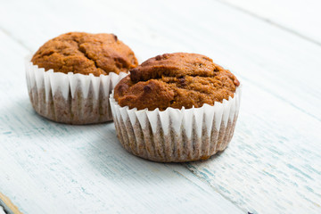 pair of chocolate muffins on white table
