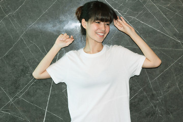 White T-shirt mockup with asian girl fashion portrait - shirt mockup model copy space dark back ground