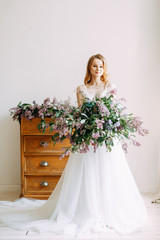  Wedding in European style. Stylish trendy bride in the Studio with a bouquet of lilacs.