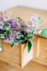  Bright and stylish interior details. Decor in the photo Studio of a bouquet of lilacs.