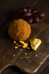 helper knoll cheese with grapes on wooden board