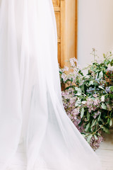  Wedding in European style. Stylish trendy bride in the Studio with a bouquet of lilacs.