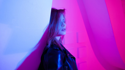 Beautiful girl dancing in retro wave on the neon light