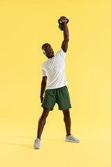 Exercise. Man doing kettlebell press workout, sports training