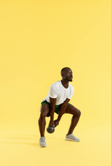 Fototapeta na wymiar Fitness training. Sports man doing kettlebell squat workout