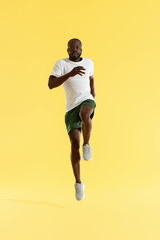Fototapeta na wymiar Workout. Sports man exercising, running on spot, cardio training