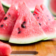 Slices of fresh juicy watermelon on bamboo board, side view. Close-up. Selective focus.