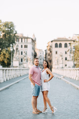 Happy couple at dawn strolling in Italy. Morning summer photo shoot in Rome.