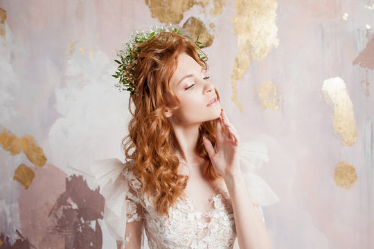 Portrait of a young beautiful woman in wedding dress with wreath of fresh flowers.