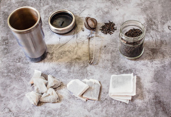 Pyramid and rectangle shaped tea bag mock up set on gray  background.  Or great black tea loose leaf. Eco-friendly alternatives.