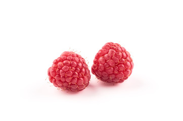 Two red raspberry Berries isolated on white background.