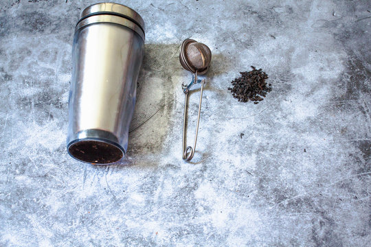 Metal thermos and tea infuser.Eco friendly Zero waste plastic free kitchen on gray  background. concept sustainable lifestyle or Recycling and ecology.