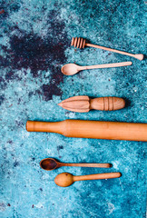 Wooden kitchen cooking utensils on blue background. Concept sustainable lifestyle or Recycling and ecology.Rustic Kitchen Decoration with wooden cutlery. Country kitchen decoration. Eco style