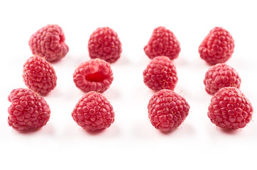 Four red raspberry Berries isolated on white background.