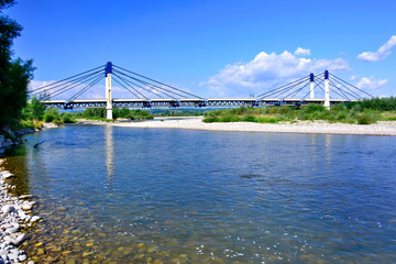 Fototapeta na wymiar St. Kinga’s bridge in Stary Sacz was built in 2006-2008 and is a crossing over the Dunajec river.