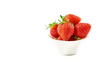 Strawberry berries on a saucer isolated on a white background.