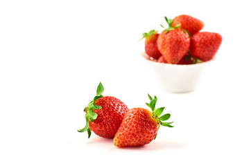 Strawberry berries on a saucer isolated on a white background.