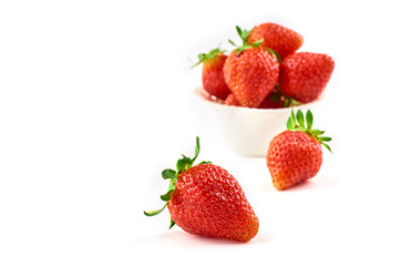 Strawberry berries on a saucer isolated on a white background.