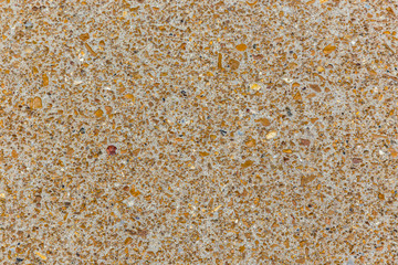 Colorful stones set in concrete on a path for a texture background.