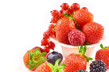 Composition of strawberries, blackberries, blueberries, raspberries and red currants on a white background.