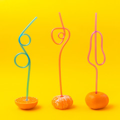 fresh juicy peeled tangerines with cocktail straw. Healthy fresh citrus juice without additives